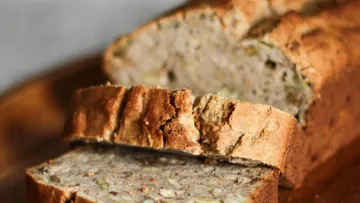 Sliced bread is freshly baked on a board.