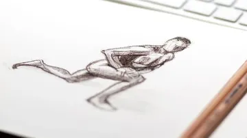 Sketch of a running male body on paper.