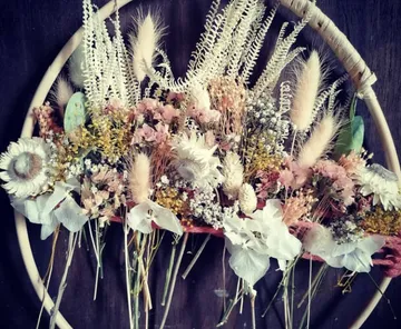 Blumenarrangement in einem Kreis, an eine Wand gehängt.