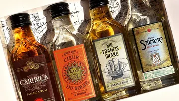 There are various bottles of rum on an old map.
