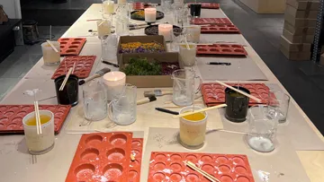 Red silicone molds are placed on a table with candles.