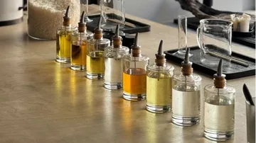 Bottles with various liquids are placed on a table.