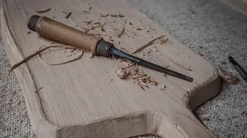 Wooden model, worked with a carving tool, on a table.