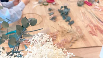 Dried flowers are in progress on a table.