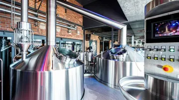 Stainless steel brewing equipment works in a modern brewery.