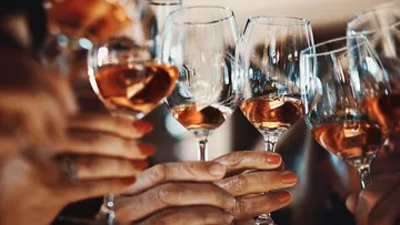Glasses of rosé wine are held when hit.