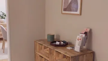 Wooden dresser with decoration, objects on shelf, quiet space.