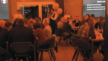People eat and drink in a festive restaurant.