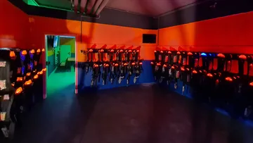Laser weapons hang on walls, wait in a dark room.