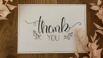 Karte mit dem Text „thank you“ und dekorativen Pflanzen.