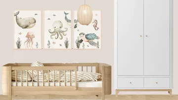 Small cot with maritime pictures and white closet.
