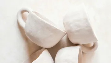 Cups made of unfired clay close together on the surface.