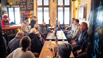 Group of people sitting together in a bar.