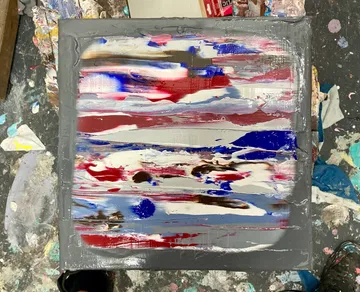 Colored painting on canvas, messy art space.