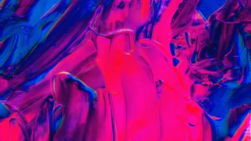 Colourful areas of color flow into each other on an abstract background.