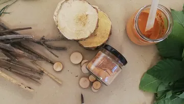 Pieces of wood and glass containers lie on a table.