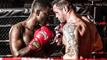 Two boxers face each other, ready to fight.