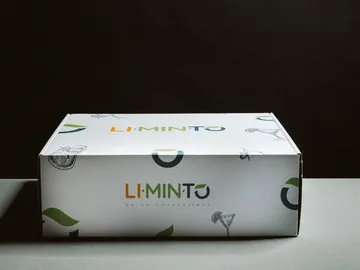 A box is standing on a table against a black background.