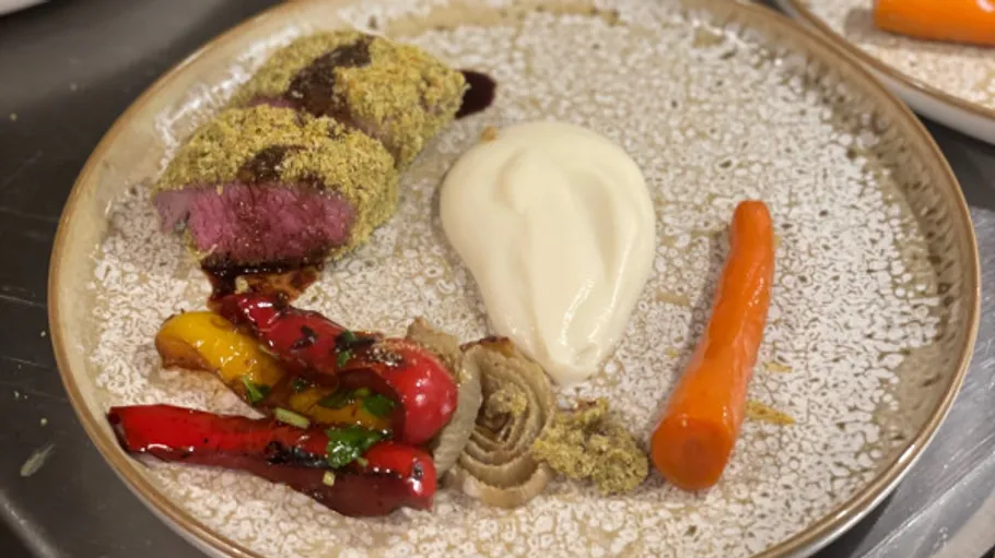 An artfully prepared plate of meat and vegetables.