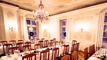 Elegant dining room with decorated table and chandelier.