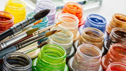 Hold brushes over colorful colored glasses on a table.