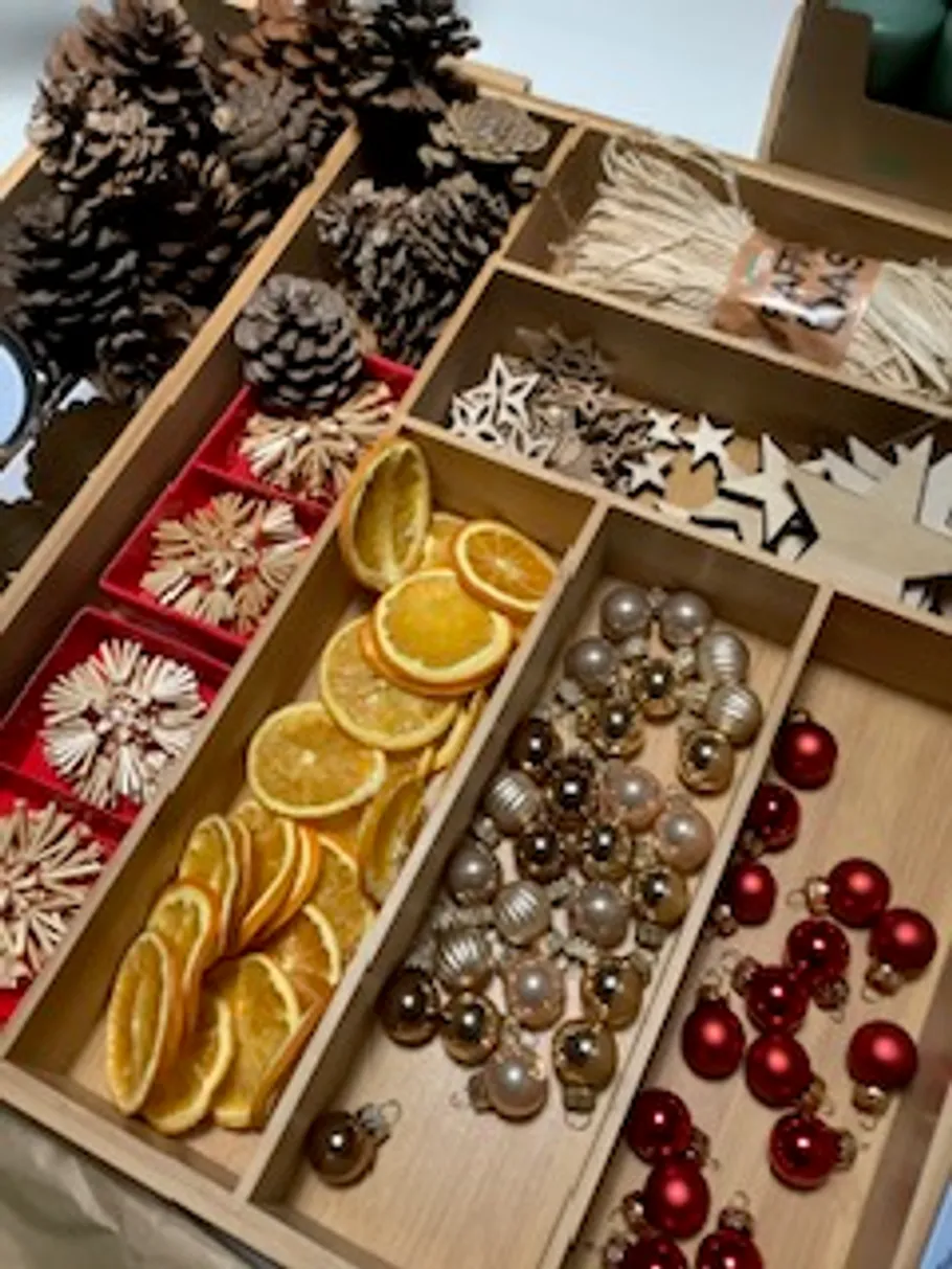Holzkiste mit Weihnachts-Bastelzubehör.