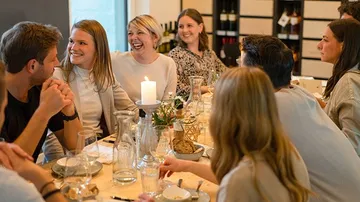 A group of smiling people are sitting at a table.
