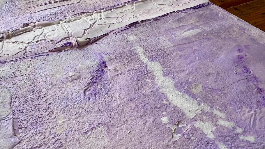 Textured purple surface with cracks and streaks.