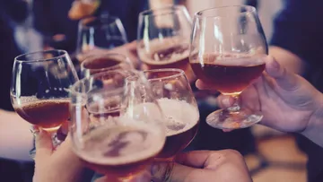 Six glasses clash to promote a celebration.