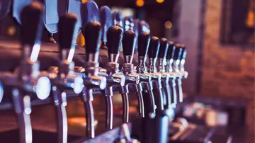 Taps are available to serve drinks in a bar.