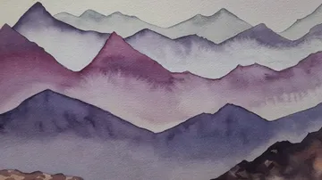 Mountains in soft colors that overlap in the background.