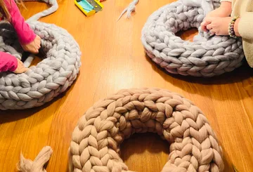 Weave shaped wreaths on a wooden table.