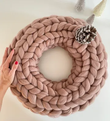 Round woven wreath on a table, hand held