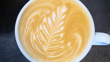 Nice latte style coffee mug on creamy foam
