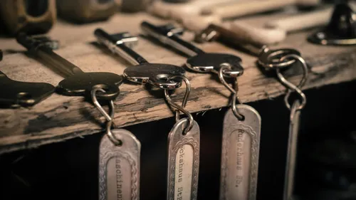 Keys hang on a wooden surface with labels.