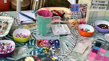 Colourful beads are spread out on a table.