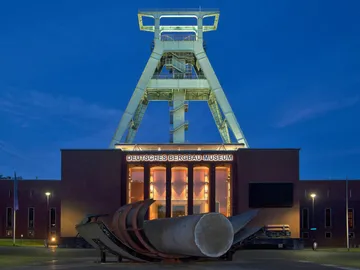Museum shows mining history, illuminated at night, quiet surroundings.
