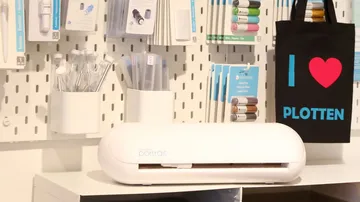 Cricut machine cuts materials in a creative space