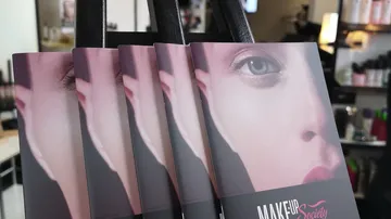 Make-up brochures are displayed in a beauty salon.