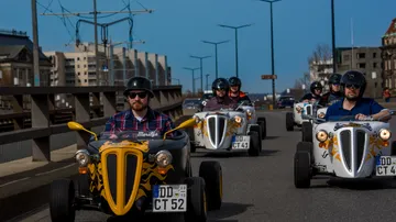 Small cars drive on a road bridge in the city.