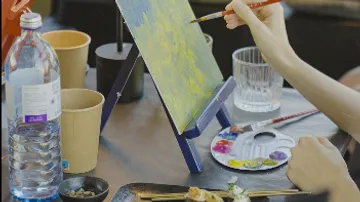Photo frame, a person paints with a brush and paints.