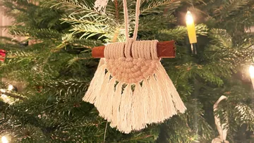 Decorative macrame pendant hangs on Christmas tree