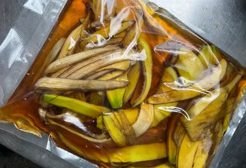 Banana pieces marinated in a bag in a liquid.