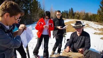 Group of people looking at a hiking map.