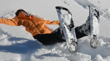 A person is lying in the snow and enjoying the peace and quiet.