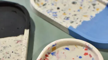 Colorful terrazzo trays with varied designs.