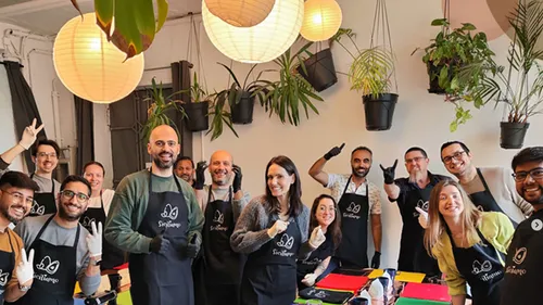A group of people are smiling and posing in a room.