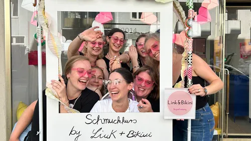 Group of women pose cheerfully in a frame.