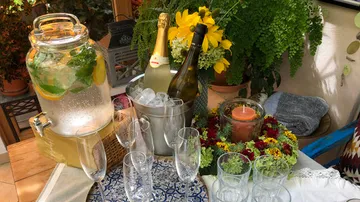 Temporary drinks area with refreshing cocktails and flowers.