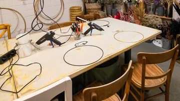 Craft table with hot glue guns and wire materials for decoration